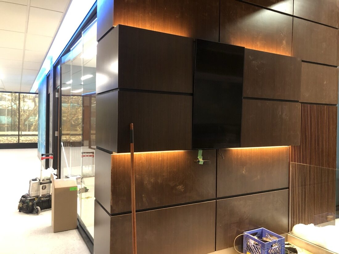 Warm linear lighting integrated into architectural millwork on the Good Sam set