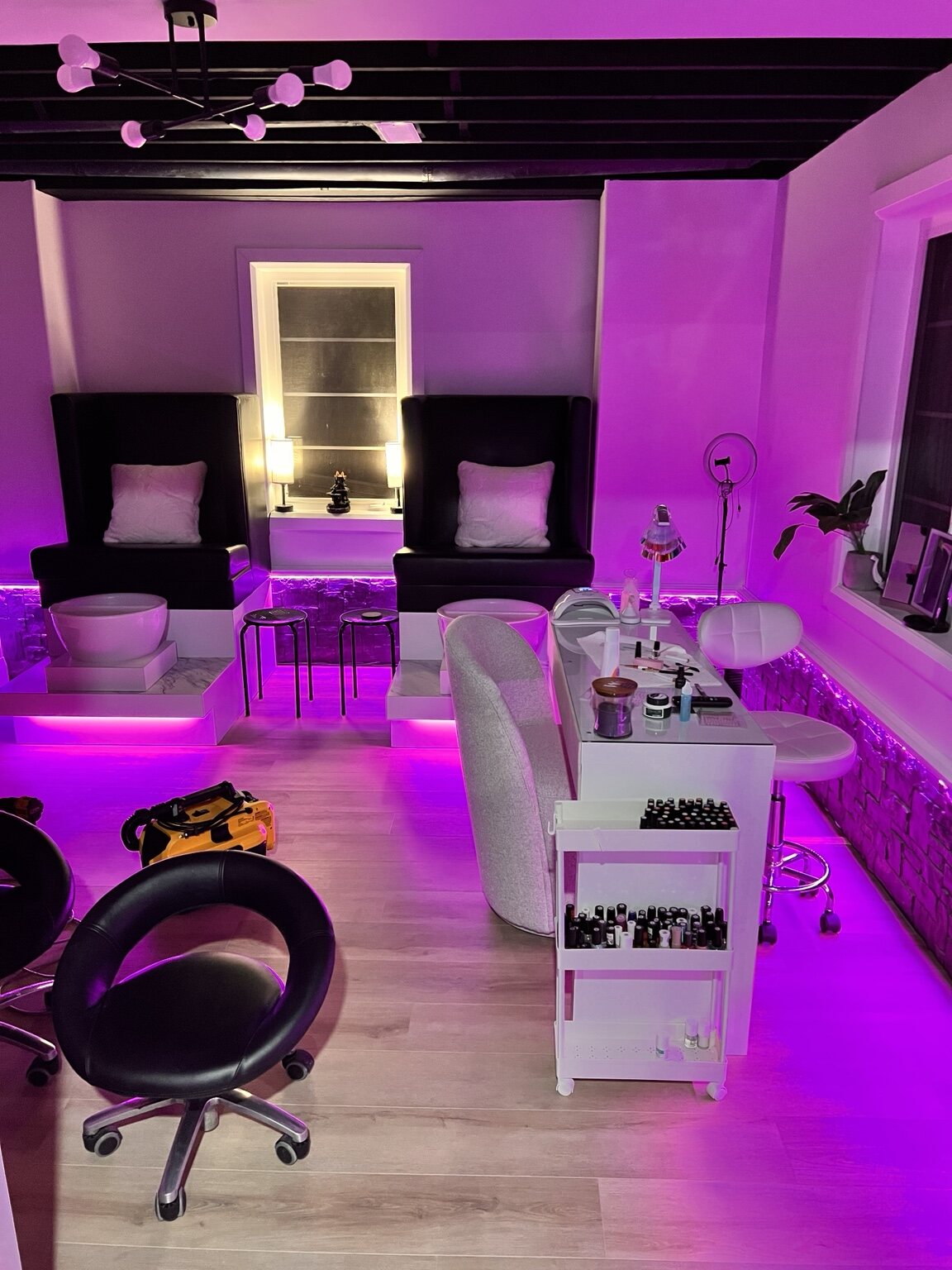 Residential nail salon illuminated with magenta and violet LED lighting